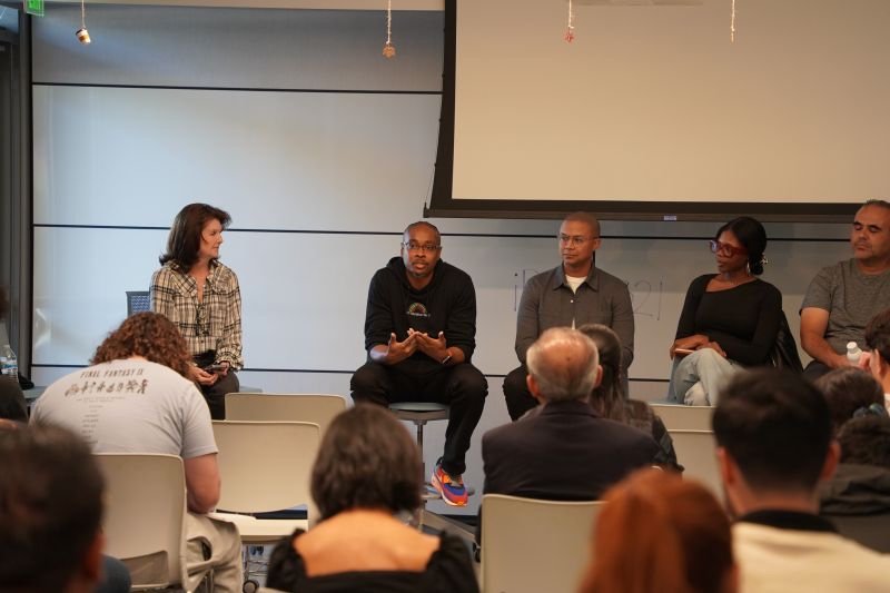 Kenan speaking on a panel discussion